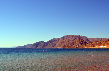 Fototapeta na wymiar The view of Dahab lagoon in the background of distant mountains. The Sinai peninsula, Egypt.