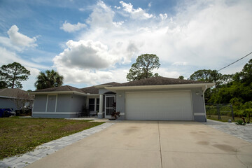 Fototapeta premium Wide garage double door and concrete driveway of new modern american house