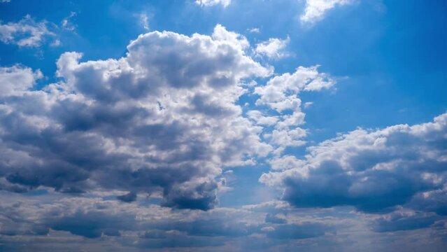 Clouds in the blue sky slowly move and change shape, Timelapse. Layered cirrus clouds dissolve in cloud space. Majestic sky. Summer cloudscape, time lapse. Change weather. Clouds background. 4K