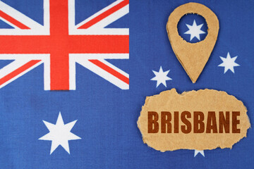 The flag of Australia has a geolocation symbol and a sign with the inscription - Brisbane