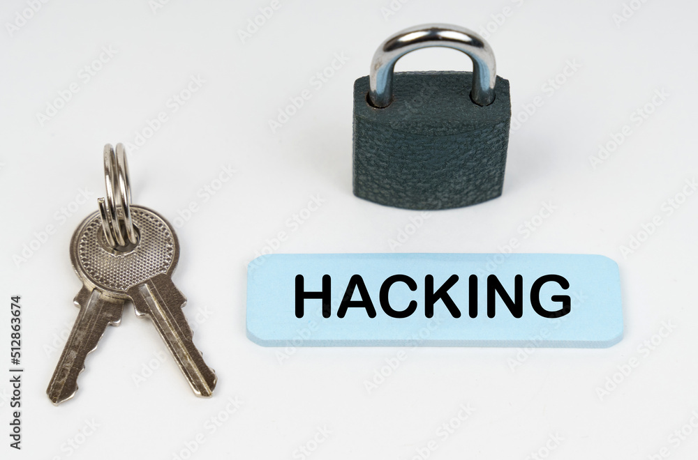 Poster on a white surface there is a lock, keys and a blue sign with the inscription - hacking