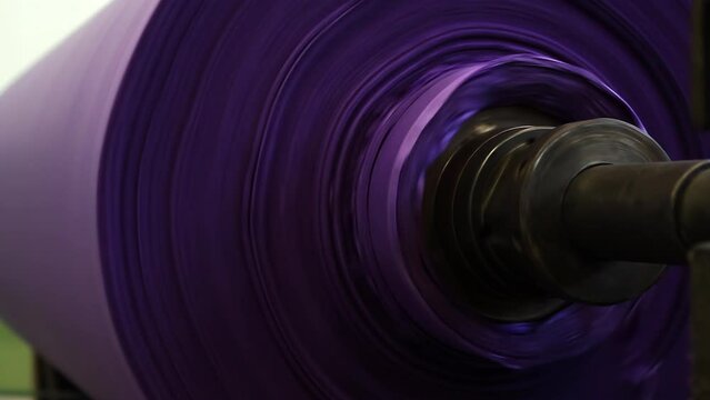 Drum of Purple Paper Rolling at a Paper Machine in Pulp and Paper Mill Plant. Close Up. 4K Resolution.