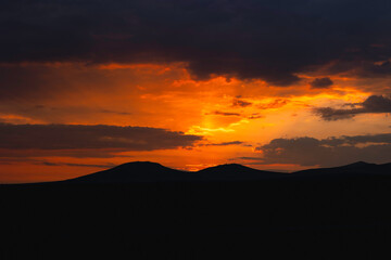 Sunrise or sunset over the hills or mountains. Morning or evening background