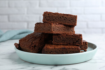 Delicious chocolate brownies on white marble table