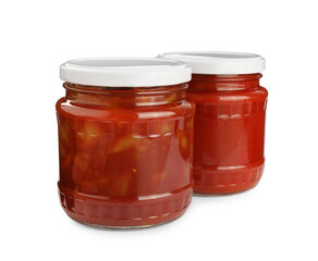 Glass jars of delicious canned lecho on white background