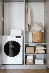 Bathroom accessories and washing machine in modern room