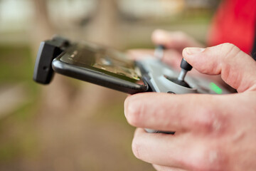 Man holding a remote control of drone.