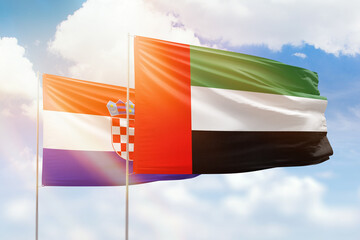 Sunny blue sky and flags of united arab emirates and croatia