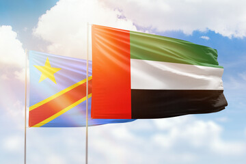 Sunny blue sky and flags of united arab emirates and dr congo