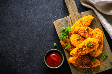 Chicken nuggets with ketchup sauce.