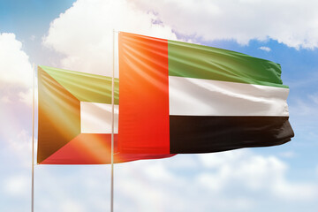 Sunny blue sky and flags of united arab emirates and kuwait