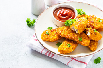 Chicken nuggets with ketchup sauce.
