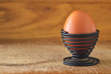 One boiled egg in a spiral-shaped metal support