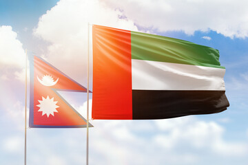 Sunny blue sky and flags of united arab emirates and nepal