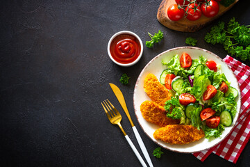 Chicken nuggets with fresh salad.