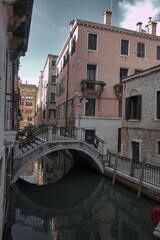 Obraz na płótnie Canvas Scenic arc bridge over small canal in residential neighborhood in Venice, Italy