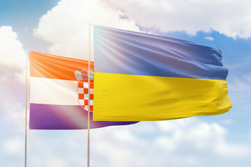 Sunny blue sky and flags of ukraine and croatia