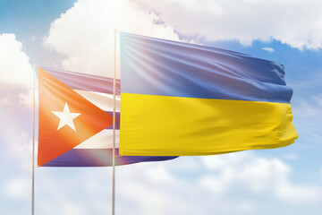 Sunny blue sky and flags of ukraine and cuba