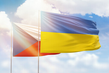 Sunny blue sky and flags of ukraine and czechia