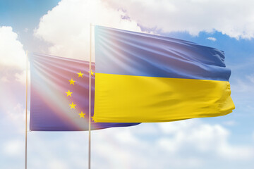 Sunny blue sky and flags of ukraine and european union