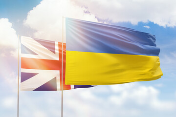 Sunny blue sky and flags of ukraine and great britain
