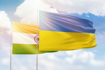 Sunny blue sky and flags of ukraine and india