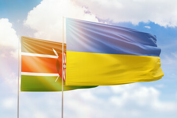 Sunny blue sky and flags of ukraine and kenya