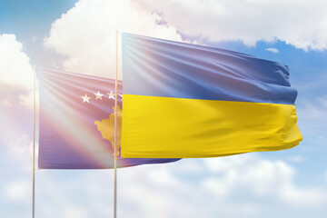 Sunny blue sky and flags of ukraine and kosovo