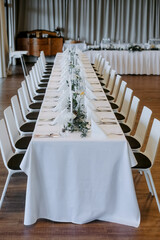 Banquet table. Decorating the table with flowers. Banquet table for a wedding.