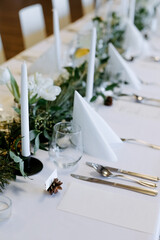 Banquet table with candles.   Decorating the table with fresh flowers.