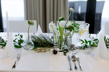 Banquet table with candles.   Decorating the table with fresh flowers.