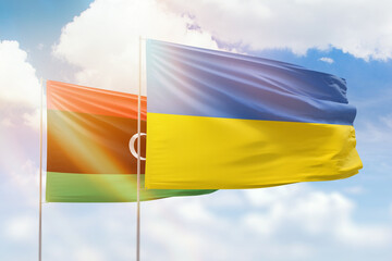 Sunny blue sky and flags of ukraine and libya