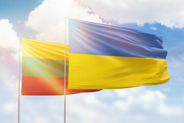 Sunny blue sky and flags of ukraine and lithuania