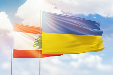 Sunny blue sky and flags of ukraine and lebanon