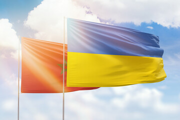 Sunny blue sky and flags of ukraine and morocco