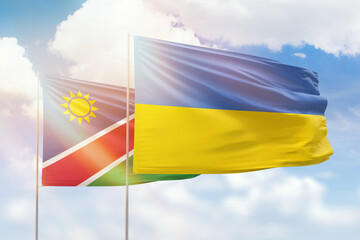 Sunny blue sky and flags of ukraine and namibia