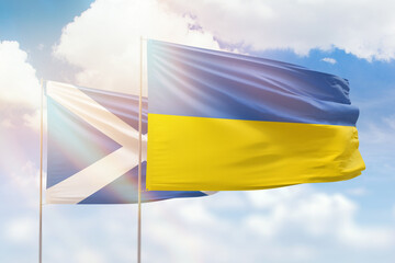 Sunny blue sky and flags of ukraine and scotland