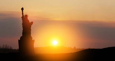 Silhouettes of The Statue of Liberty at sunset. Greeting card for Independence Day.