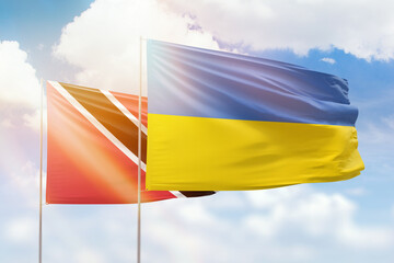Sunny blue sky and flags of ukraine and trinidad and tobago