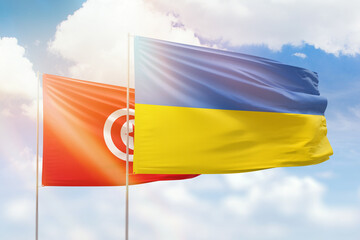 Sunny blue sky and flags of ukraine and tunisia