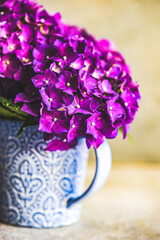Fototapeta na wymiar Ceramic cup with fresh hydrangea flowers