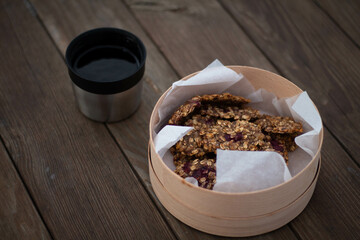 tea with cookies on a wooden table in the forest