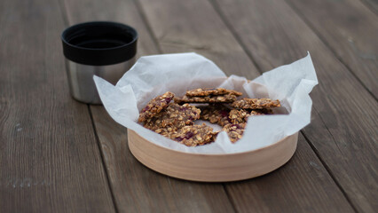 tea with cookies on a wooden table in the forest