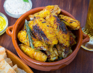 Delicious roasted chicken wings in clayware with delicate mustard dipping sauce....