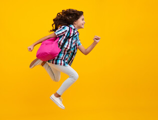 School girl with backpack. Teenager student, isolated background. Learning and knowledge. Go study. Crazy run and jump. Children education concept.