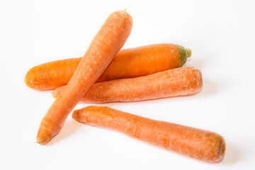 several carrots are lying on a white background