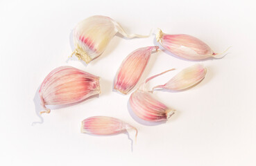 Obraz na płótnie Canvas a few cloves of garlic lie on a white background