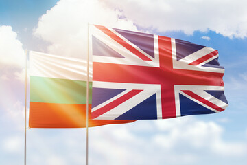 Sunny blue sky and flags of united kingdom and bulgaria