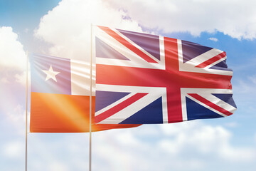 Sunny blue sky and flags of united kingdom and chile