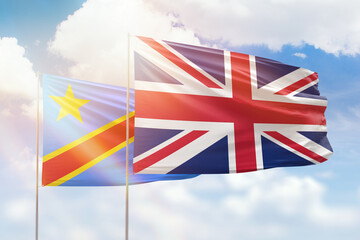 Sunny blue sky and flags of united kingdom and dr congo